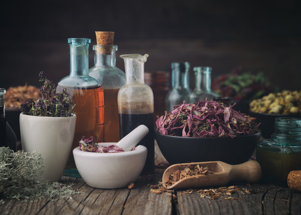 glass bottles, pestle and mortars with medicinal herbs